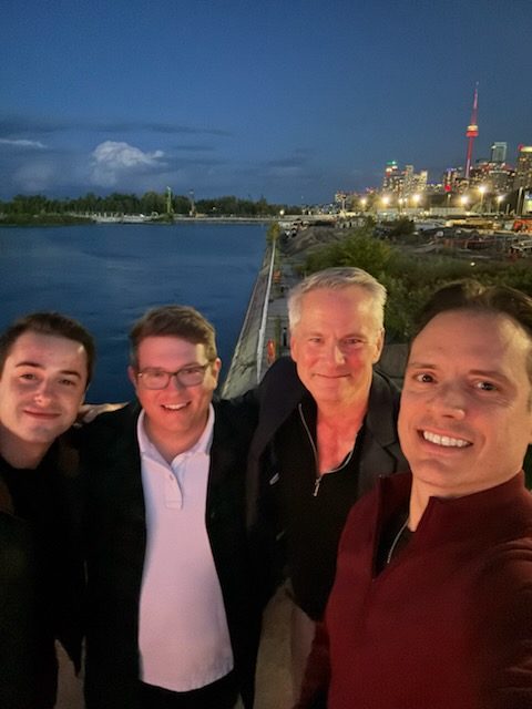 LNE Group team members on a waterfront at night